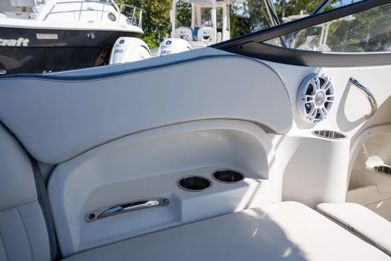 Slide: The Image of 2024 Stingray 211DC boat interior with cup holders and speaker. - 13