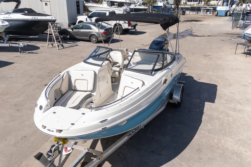 Slide: The Image of 2024 Stingray 211DC boat on trailer, featuring sleek design and spacious seating. - 18