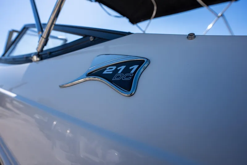 Slide: The Image of 2024 Stingray 211DC boat emblem close-up with sleek design. - 4
