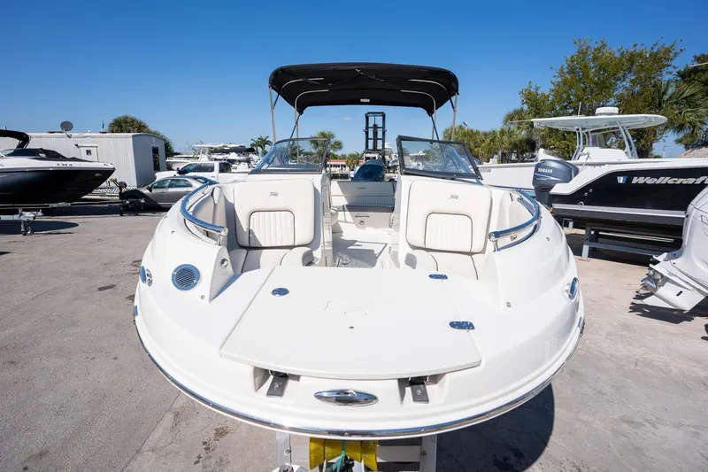 Slide: The Image of 2024 Stingray 211DC boat with sleek design, white exterior, and spacious seating. - 5