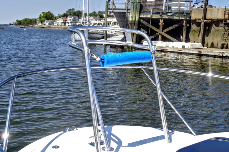 Slide: The Image of 2020 Maritime 23 Challenger boat with stainless steel railings docked by the waterfront. - 12