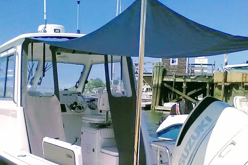 Slide: The Image of 2020 Maritime 23 Challenger boat with Suzuki engine docked at marina. - 13