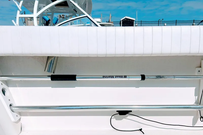 Slide: The Image of 2020 Maritime 23 Challenger boat interior with rod holder and railing. - 19