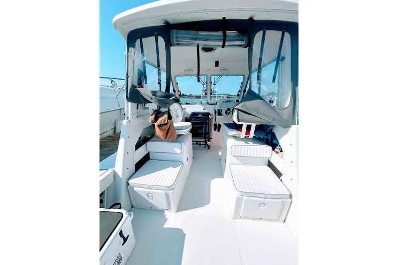 Slide: The Image of Interior view of 2020 Maritime 23 Challenger boat with seating and helm. - 24