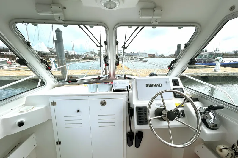 Slide: The Image of Interior view of 2020 Maritime 23 Challenger boat cockpit with steering wheel and controls. - 5
