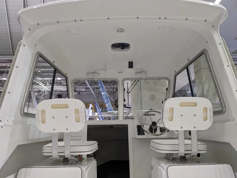 Slide: The Image of Interior view of a 2020 Maritime 23 Challenger boat with dual white seats. - 6