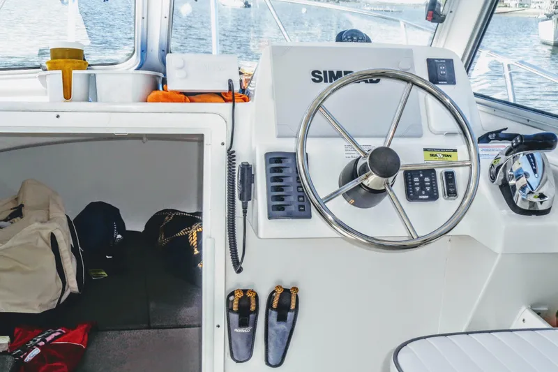 Slide: The Image of Interior view of a 2020 Maritime 23 Challenger boat cockpit with steering wheel and controls. - 8
