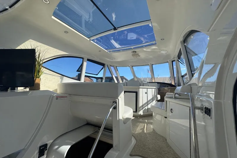 Slide: The Image of Interior of 2004 Carver 564 Cockpit Motor Yacht with skylight and modern seating. - 11