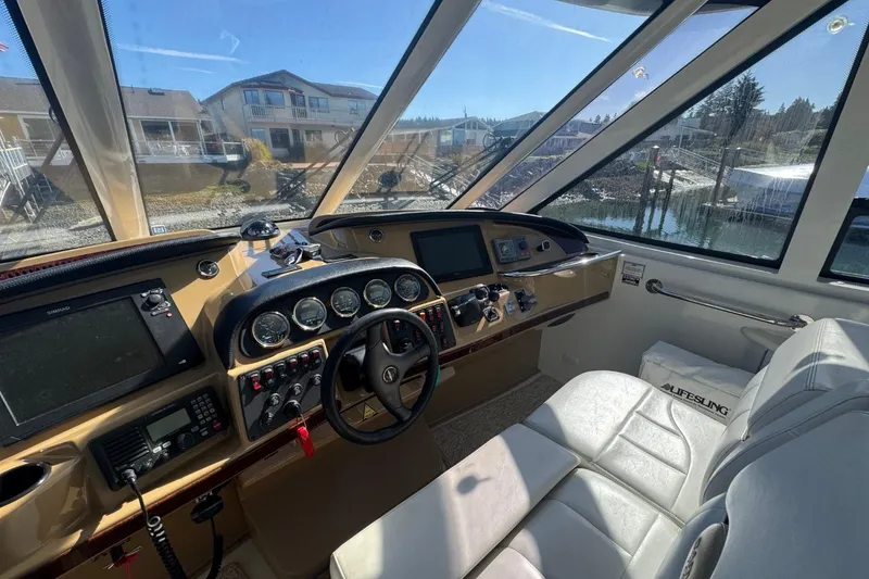 Slide: The Image of Interior cockpit of 2004 Carver 564 Cockpit Motor Yacht with navigation controls and seating. - 13