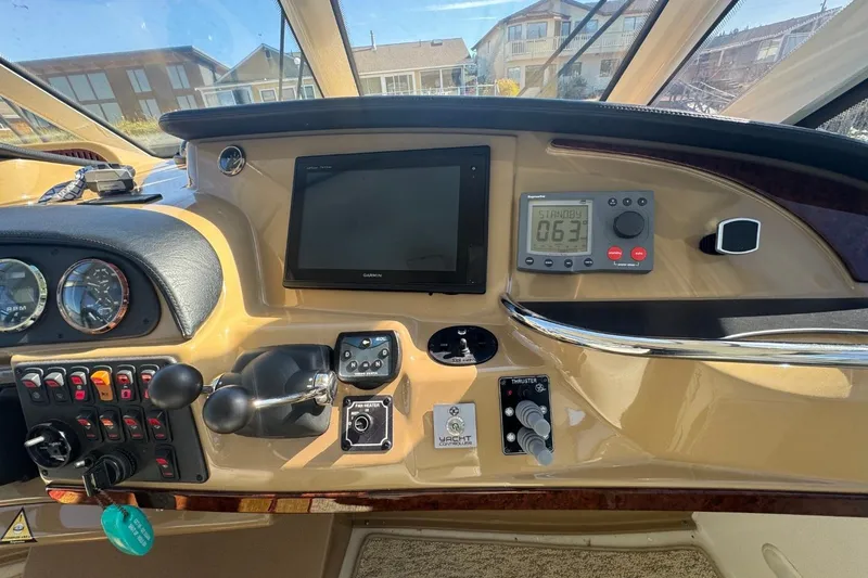 Slide: The Image of Control panel of 2004 Carver 564 Cockpit Motor Yacht with navigation and throttle controls. - 14