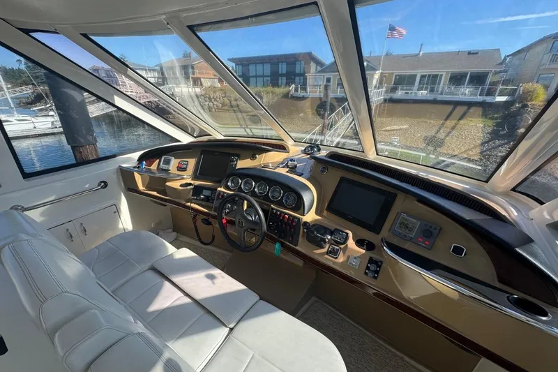 Slide: The Image of Interior view of 2004 Carver 564 Cockpit Motor Yacht helm with modern controls and panoramic windows. - 15