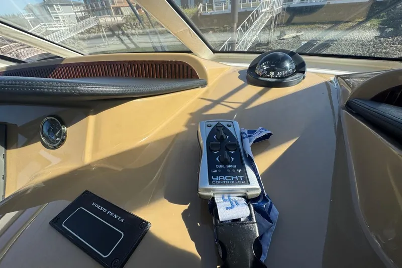 Slide: The Image of Control panel of 2004 Carver 564 Cockpit Motor Yacht with yacht controller and compass. - 17