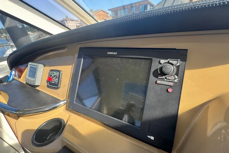 Slide: The Image of Dashboard of 2004 Carver 564 Cockpit Motor Yacht with navigation equipment. - 18