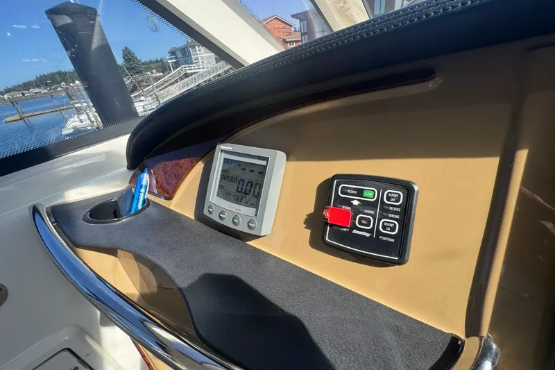 Slide: The Image of 2004 Carver 564 Cockpit Motor Yacht dashboard with navigation controls and display. - 19