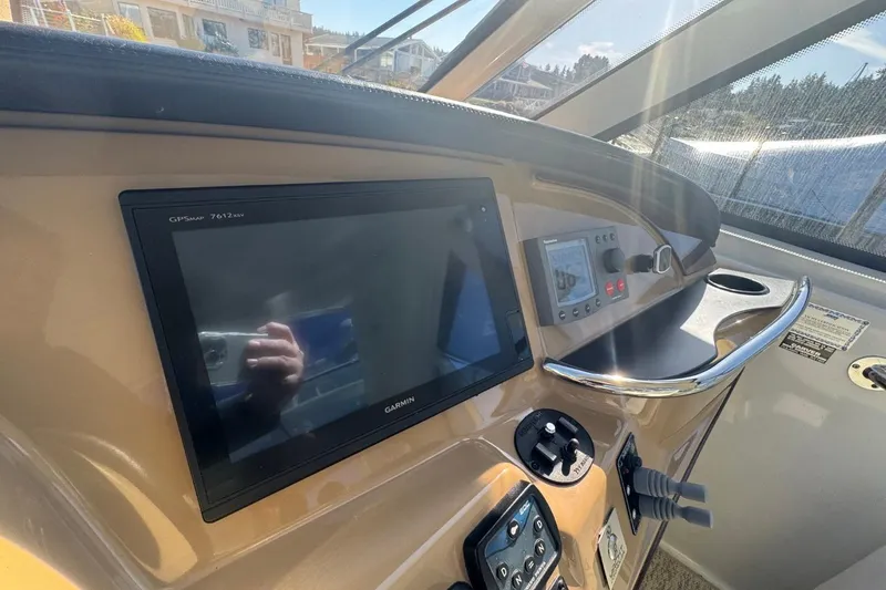 Slide: The Image of 2004 Carver 564 Cockpit Motor Yacht helm with Garmin GPS and control panel. - 21