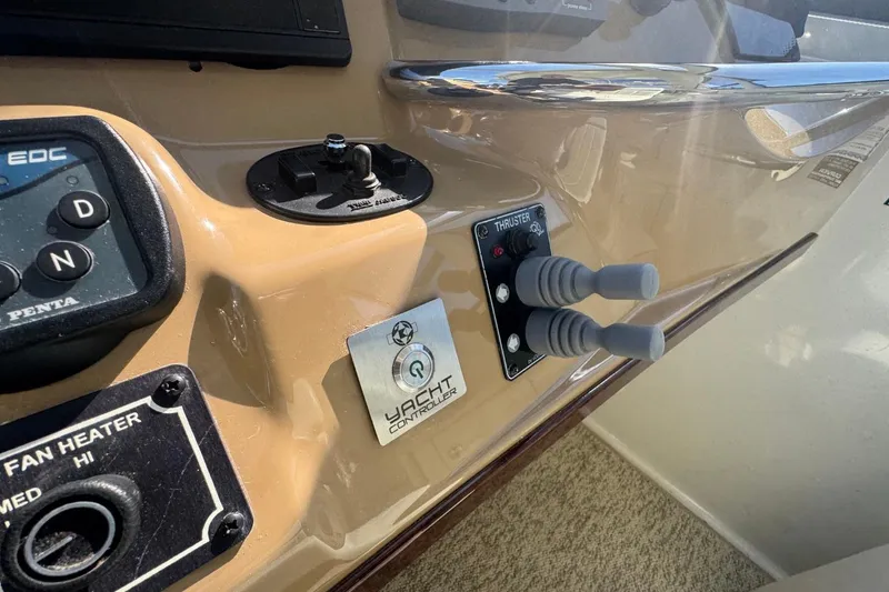 Slide: The Image of Control panel of 2004 Carver 564 Cockpit Motor Yacht with thruster and fan heater controls. - 22