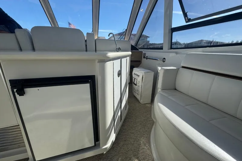 Slide: The Image of Interior of 2004 Carver 564 Cockpit Motor Yacht with white seating and cabinetry. - 25