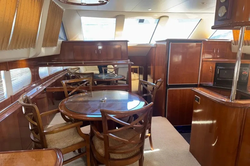 Slide: The Image of Luxurious interior of 2004 Carver 564 Cockpit Motor Yacht with dining area and kitchen. - 32