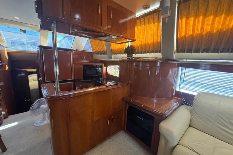 Slide: The Image of Interior of 2004 Carver 564 Cockpit Motor Yacht with wood cabinetry and seating. - 33