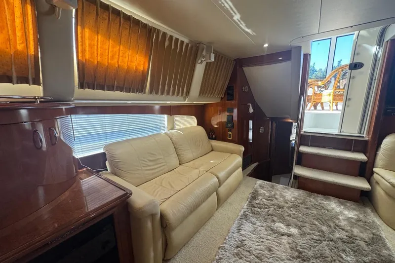 Slide: The Image of Luxurious interior of 2004 Carver 564 Cockpit Motor Yacht with leather seating and plush carpet. - 35