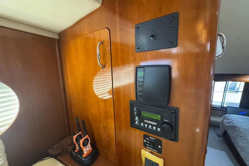 Slide: The Image of Interior of 2004 Carver 564 Cockpit Motor Yacht with control panel and radio. - 36