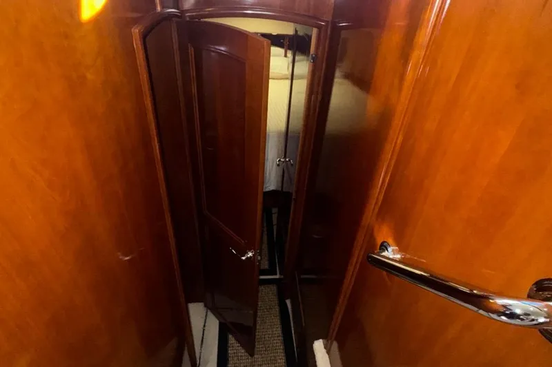 Slide: The Image of Interior view of 2004 Carver 564 Cockpit Motor Yacht with wooden doors and hallway. - 38