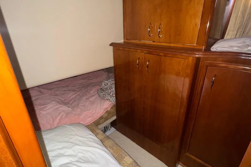 Slide: The Image of Interior cabin of 2004 Carver 564 Cockpit Motor Yacht with wooden cabinetry and bedding. - 39