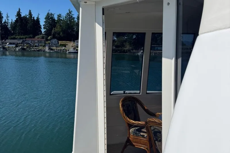 Slide: The Image of 2004 Carver 564 Cockpit Motor Yacht with scenic waterfront view. - 4