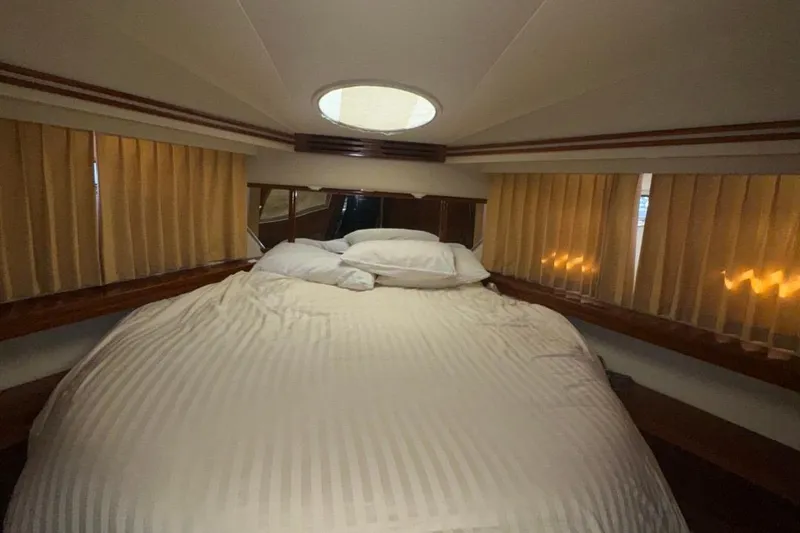 Slide: The Image of Luxurious bedroom in 2004 Carver 564 Cockpit Motor Yacht with cozy bedding. - 43
