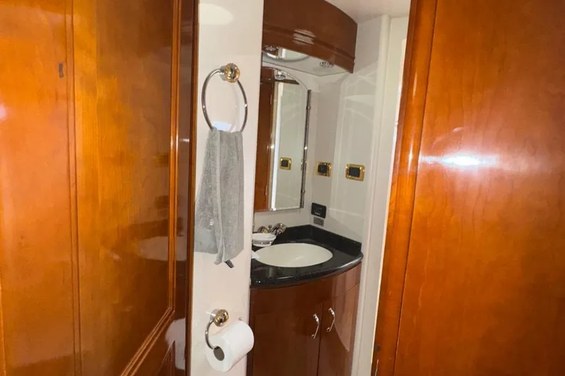 Slide: The Image of Bathroom interior of 2004 Carver 564 Cockpit Motor Yacht with wood cabinetry and modern fixtures. - 44