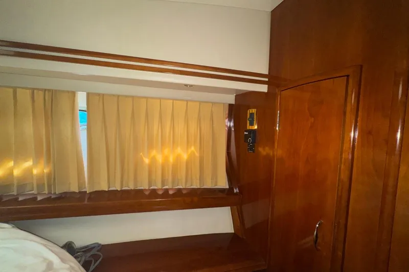 Slide: The Image of Interior of 2004 Carver 564 Cockpit Motor Yacht with wood paneling and curtains. - 45