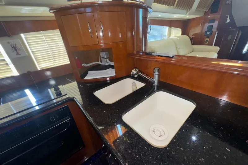 Slide: The Image of Interior of 2004 Carver 564 Cockpit Motor Yacht with modern kitchen and dual sinks. - 49