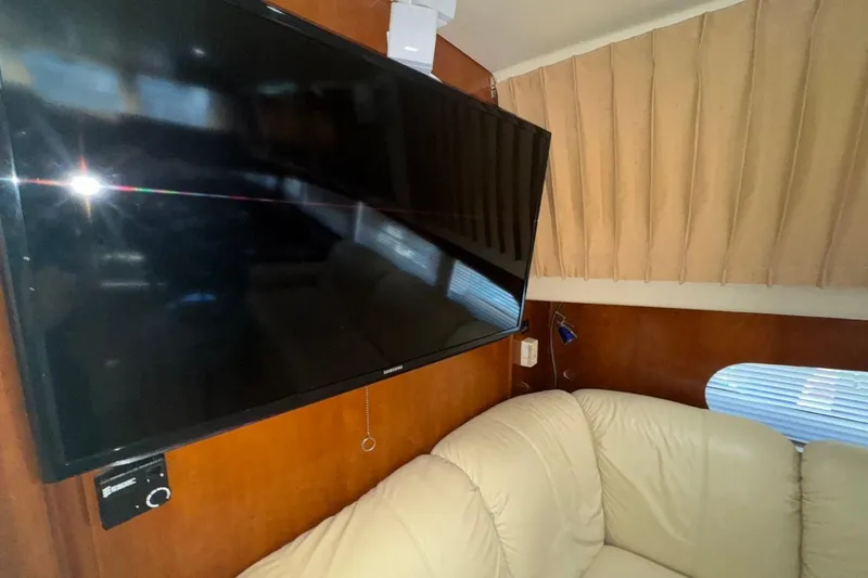 Slide: The Image of Interior of 2004 Carver 564 Cockpit Motor Yacht with TV and beige sofa. - 50