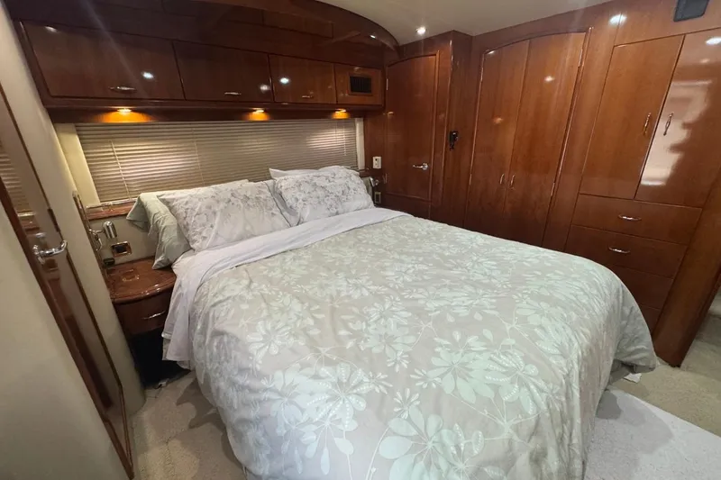 Slide: The Image of Luxurious bedroom interior of 2004 Carver 564 Cockpit Motor Yacht with elegant wood finishes. - 53