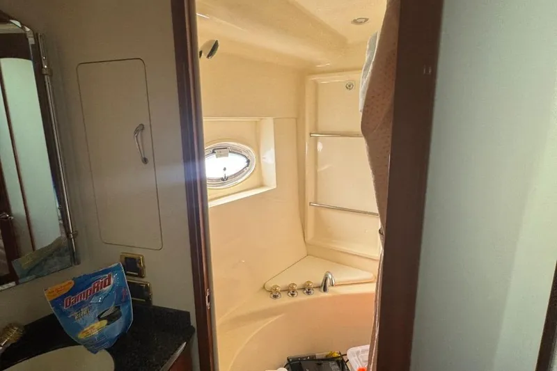 Slide: The Image of Bathroom interior of 2004 Carver 564 Cockpit Motor Yacht with shower and porthole window. - 57
