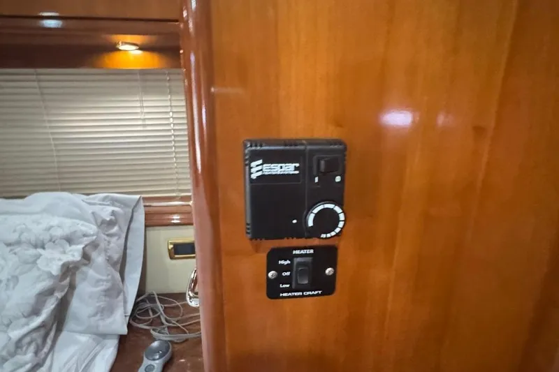 Slide: The Image of Control panel inside 2004 Carver 564 Cockpit Motor Yacht, featuring heater settings. - 59