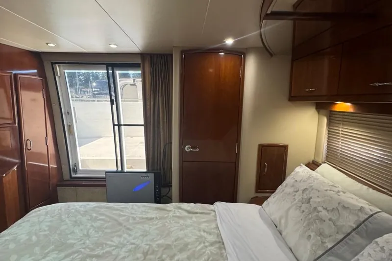 Slide: The Image of Luxurious bedroom interior of 2004 Carver 564 Cockpit Motor Yacht with elegant wood finishes. - 60