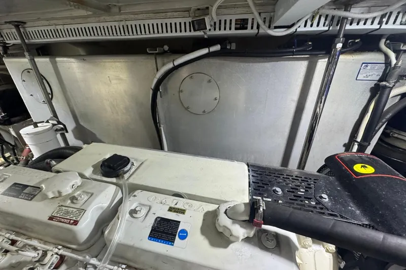 Slide: The Image of Engine room of 2004 Carver 564 Cockpit Motor Yacht, showcasing machinery and components. - 64