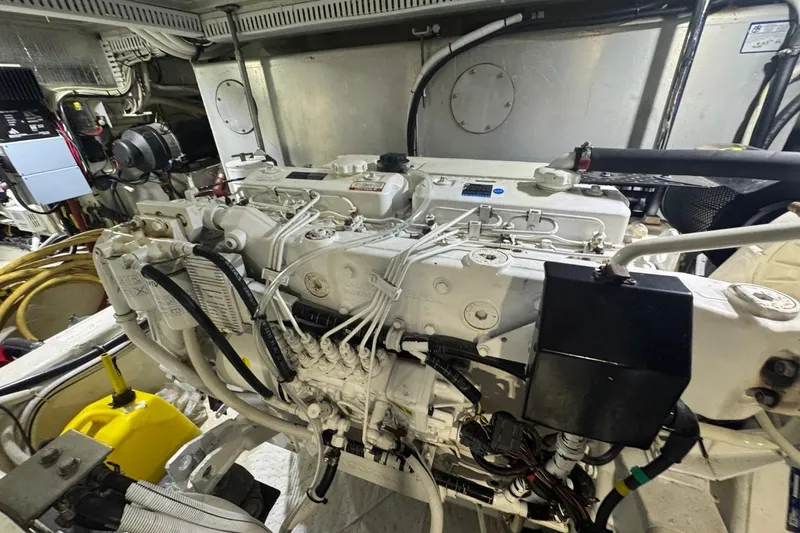 Slide: The Image of Engine room of a 2004 Carver 564 Cockpit Motor Yacht, showcasing detailed machinery and components. - 65