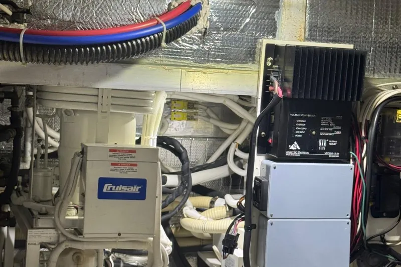 Slide: The Image of Engine room of 2004 Carver 564 Cockpit Motor Yacht with electrical components and wiring. - 71