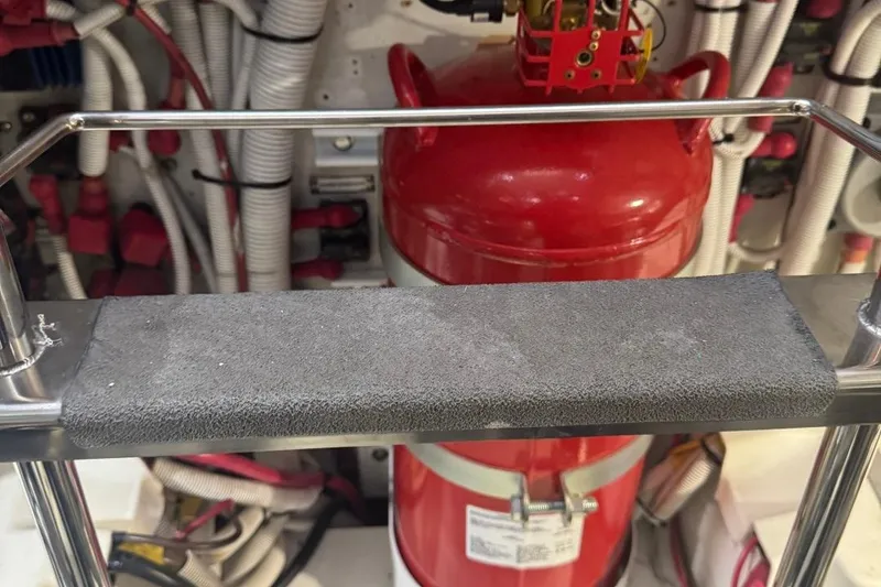 Slide: The Image of Engine room of 2004 Carver 564 Cockpit Motor Yacht with fire extinguisher and wiring. - 73