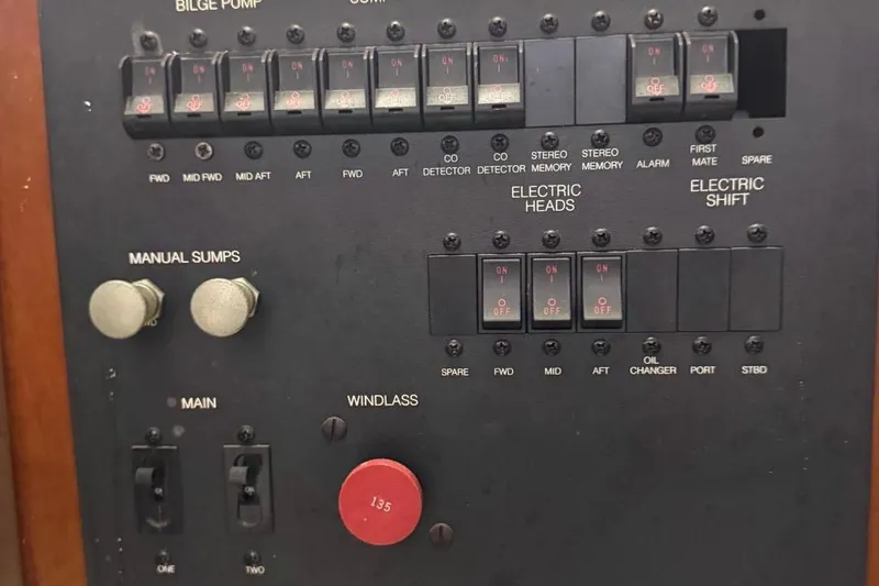 Slide: The Image of Control panel of a 2004 Carver 564 Cockpit Motor Yacht with switches and labels. - 74