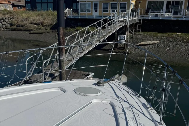 Slide: The Image of 2004 Carver 564 Cockpit Motor Yacht docked near a wooden pier. - 75