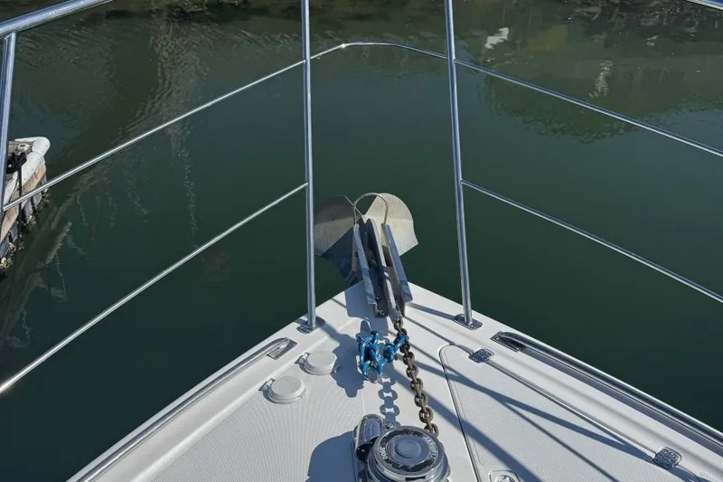 Slide: The Image of Bow view of 2004 Carver 564 Cockpit Motor Yacht with anchor and railing. - 76