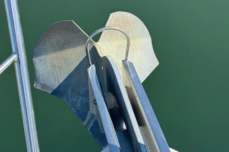 Slide: The Image of Anchor of 2004 Carver 564 Cockpit Motor Yacht against green water background. - 77