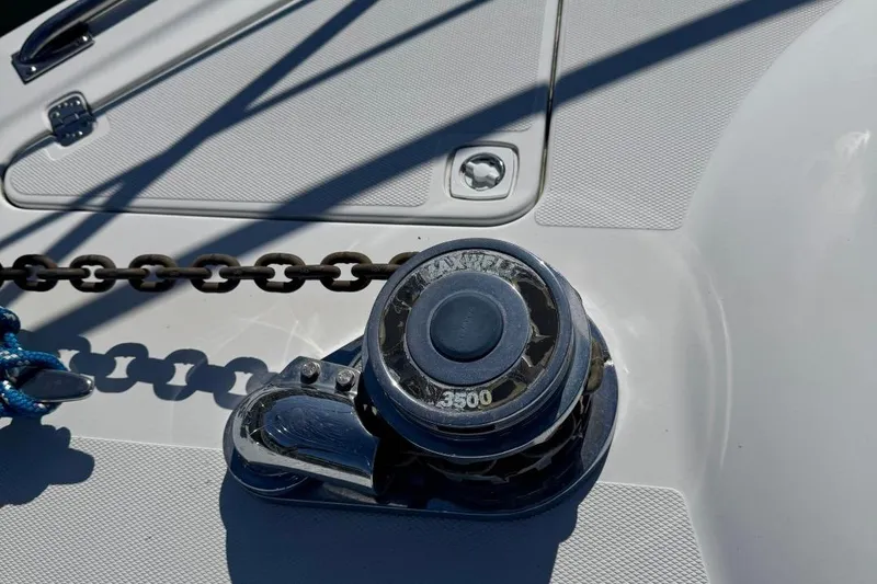 Slide: The Image of Anchor windlass on 2004 Carver 564 Cockpit Motor Yacht deck with chain and shadows. - 78