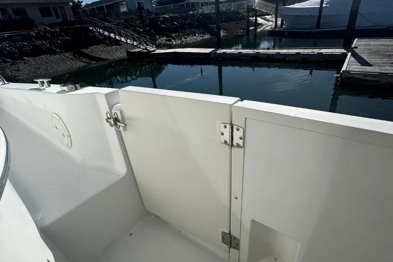 Slide: The Image of 2004 Carver 564 Cockpit Motor Yacht docked, showing deck and water view. - 8