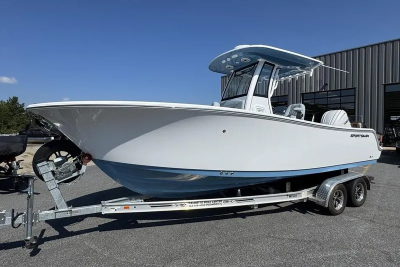 Slide: The Image of 2026 Sportsman Heritage 231 Center Console boat cruising on a scenic lake. - 1