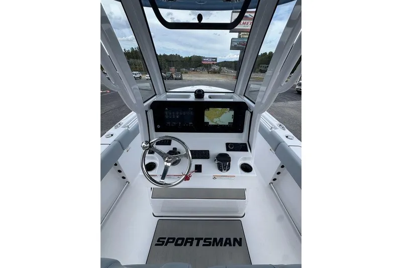 Slide: The Image of 2026 Sportsman Heritage 231 Center Console boat interior with steering wheel and navigation display. - 15