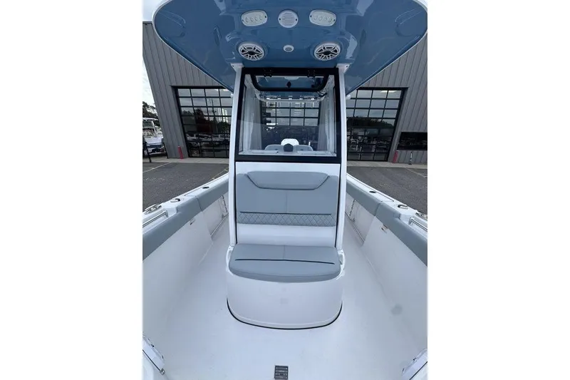 Slide: The Image of 2026 Sportsman Heritage 231 Center Console boat interior with seating and overhead speakers. - 20